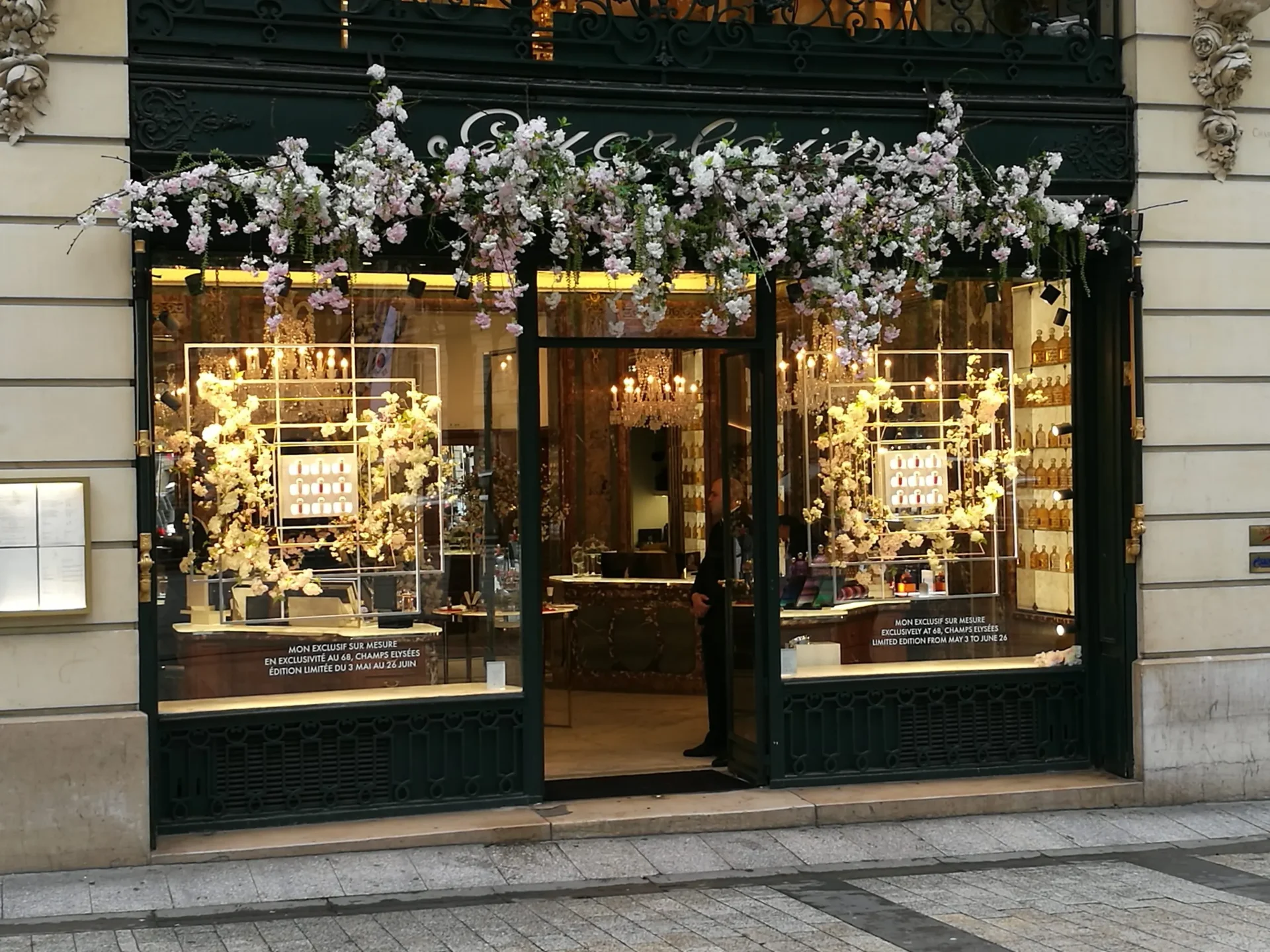 Elegant Parisian shopfront framed in florals.