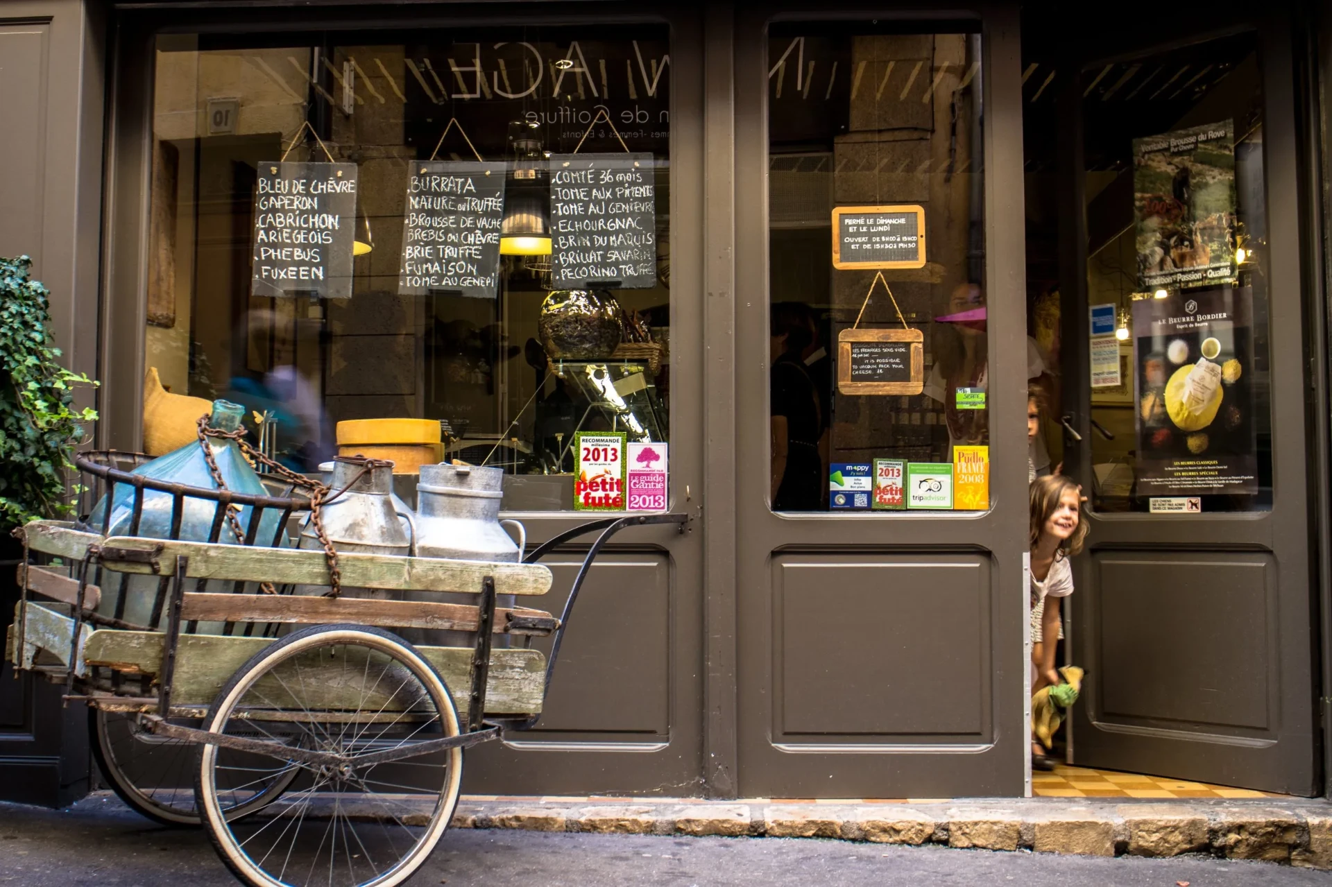 Charming French shopfront with handwritten signs and character.